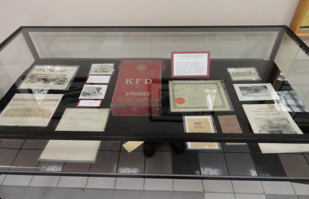 The right case displays items representing the first half of the century